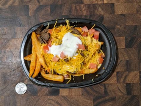 Try our Yellowbird® Nacho Fries – it’s crispy Nacho Fries topped with Yellowbird® sauce, marinated, grilled steak, nacho cheese sauce, tomatoes, reduced-fat sour cream, and cheddar cheese. Order ahead online for pickup or delivery. 